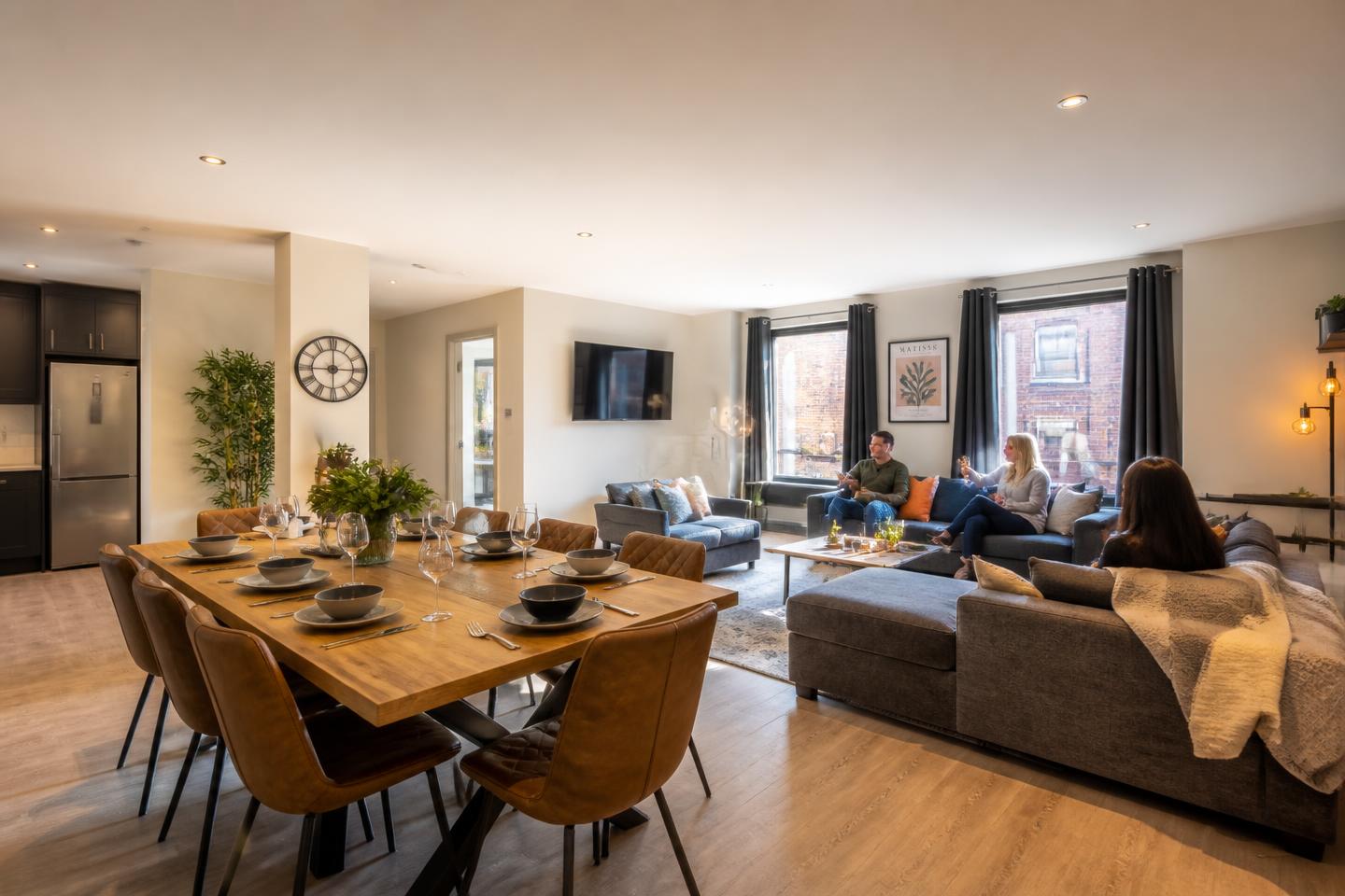 Group of guests relaxing in a spacious open-plan dining and living area